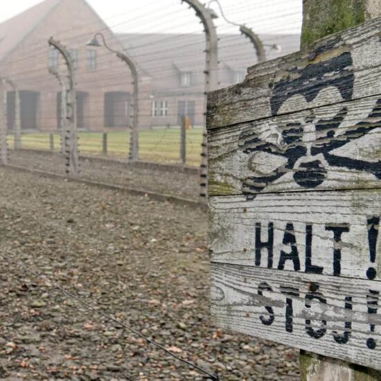 board with the inscription halt in Auschwitz-Birkenau Museum